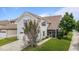 View of the rear exterior showcasing a screened-in patio and two-car garage with a well-kept lawn at 1172 Pemberly Ave, Morrisville, NC 27560