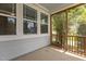 Enclosed porch features multiple windows and a wood railing and overlooks the community at 1172 Pemberly Ave, Morrisville, NC 27560