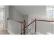 A staircase with wooden rails and white balusters, leading to the upper level of the home at 1172 Pemberly Ave, Morrisville, NC 27560