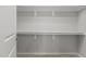 Spacious walk-in closet featuring neutral paint, carpet flooring and shelf and rod system for organized storage at 1172 Pemberly Ave, Morrisville, NC 27560