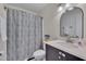 Modern bathroom with sleek vanity, decorative mirror, and a shower with a stylish shower curtain at 1302 Valley Run Dr, Durham, NC 27707