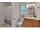 Functional bathroom with tile floors, vanity, and a shower with a modern shower curtain at 1302 Valley Run Dr, Durham, NC 27707
