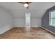 Bright and airy bedroom showcasing sloped ceilings, a ceiling fan, and hardwood floors at 1302 Valley Run Dr, Durham, NC 27707