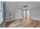 Spacious bedroom featuring hardwood floors, built-in shelves, and multiple doorways at 1302 Valley Run Dr, Durham, NC 27707