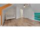Cozy bedroom with a white crib, built-in shelves, and wood-look flooring at 1302 Valley Run Dr, Durham, NC 27707