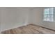 Inviting bedroom showcasing a hardwood floor, neutral walls, and a window at 1302 Valley Run Dr, Durham, NC 27707