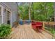 Relaxing wooden deck with comfortable seating and views of the wooded backyard at 1302 Valley Run Dr, Durham, NC 27707