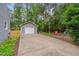 Long driveway leading to a detached garage and a basketball hoop at 1302 Valley Run Dr, Durham, NC 27707