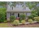 Charming home featuring dormer windows, a brick walkway, and lush landscaping at 1302 Valley Run Dr, Durham, NC 27707