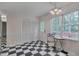 Bright kitchen nook features a table setting with natural light and adjacent storage and access to outdoor living space at 1302 Valley Run Dr, Durham, NC 27707