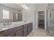 Bathroom featuring double vanity, tile flooring, tiled shower, and a walk-in closet at 132 Cotten Dr, Morrisville, NC 27560