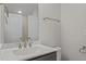 Bathroom features a white marble countertop, brushed nickel faucet, and storage at 132 Cotten Dr, Morrisville, NC 27560