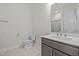 Bathroom with a light wood-look tile floor, a marble vanity, and a shower with glass doors at 132 Cotten Dr, Morrisville, NC 27560