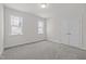 Bedroom features neutral walls, carpet flooring, natural light from two windows, and a double closet at 132 Cotten Dr, Morrisville, NC 27560