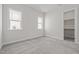 Bright bedroom featuring neutral walls, carpet flooring, natural light, and an open closet at 132 Cotten Dr, Morrisville, NC 27560