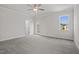 Carpeted bedroom provides a ceiling fan, natural lighting, and private balcony access at 132 Cotten Dr, Morrisville, NC 27560