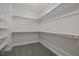 Walk-in closet featuring carpeted floor, shelving, and a window for lighting at 132 Cotten Dr, Morrisville, NC 27560