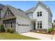 Two story home boasts stone accents, attached garage, and manicured lawn at 132 Cotten Dr, Morrisville, NC 27560