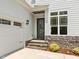 Attached garage with stone accents, front door, and stone steps at 132 Cotten Dr, Morrisville, NC 27560