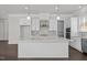 Modern kitchen with white cabinets, stainless steel appliances, island and mosaic backsplash at 132 Cotten Dr, Morrisville, NC 27560