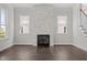 Bright living room showcases a modern fireplace, hardwood floors, and abundant natural light at 132 Cotten Dr, Morrisville, NC 27560
