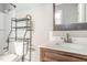 A bathroom featuring a vanity, sink, toilet, and shelf unit in the shower/tub area at 1401 Robinhood Rd, Durham, NC 27701