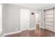 Bedroom with hardwood floors, a white door, and a decorative sliding barn door at 1401 Robinhood Rd, Durham, NC 27701