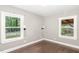 A bedroom showcasing hardwood floors and two windows allowing for natural light at 1401 Robinhood Rd, Durham, NC 27701