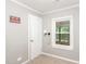 A bedroom showcasing carpet, a window and a white door at 1401 Robinhood Rd, Durham, NC 27701