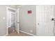 A bedroom featuring a door and neutral colors, with a sign that reads 