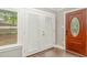 Entryway featuring wood flooring, a brown front door, and a glass-paneled double door at 1401 Robinhood Rd, Durham, NC 27701