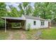 Home featuring an attached carport and stone pathway at 1401 Robinhood Rd, Durham, NC 27701