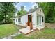 Home exterior showcasing a brown front door and white siding at 1401 Robinhood Rd, Durham, NC 27701