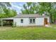 Exterior side-view of home with white siding and adjacent covered parking at 1401 Robinhood Rd, Durham, NC 27701