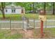 Property featuring a white picket fence, mailbox, and swing set at 1401 Robinhood Rd, Durham, NC 27701