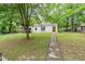 Charming single-story home featuring a stone pathway and lush greenery at 1401 Robinhood Rd, Durham, NC 27701