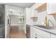 A kitchen showcasing white cabinets, stainless steel appliances and view to the living room at 1401 Robinhood Rd, Durham, NC 27701