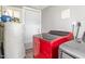 A utility room with modern red and grey washing machines and space for storage at 1401 Robinhood Rd, Durham, NC 27701