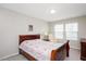 Bedroom featuring large windows, neutral walls, carpet flooring, and a wooden bed at 1416 Southpoint Trl, Durham, NC 27713