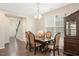 Bright dining room showcases a traditional table set and light fixture at 1416 Southpoint Trl, Durham, NC 27713