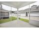 Relaxing screened-in porch with views of the backyard and neighboring garages at 1416 Southpoint Trl, Durham, NC 27713