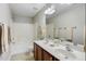 Bathroom featuring double sinks, a soaking tub with shower, and neutral tile flooring at 160 Chandler Springs Dr, Holly Springs, NC 27540