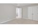 Neutral bedroom featuring fresh paint, carpet, and closet doors for ample storage space at 160 Chandler Springs Dr, Holly Springs, NC 27540