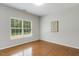 Bright bedroom features wood floors and a window with views of backyard at 160 Chandler Springs Dr, Holly Springs, NC 27540