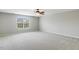 Spacious bedroom features carpet, ceiling fan, and natural light from the large window at 160 Chandler Springs Dr, Holly Springs, NC 27540