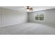 Carpeted bedroom with neutral walls, a ceiling fan, and a large window at 160 Chandler Springs Dr, Holly Springs, NC 27540