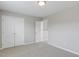 Neutral bedroom featuring fresh paint, carpet, and closet doors for ample storage space at 160 Chandler Springs Dr, Holly Springs, NC 27540