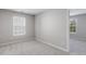 Bedroom featuring carpet, natural light, and a view into an adjoining room at 160 Chandler Springs Dr, Holly Springs, NC 27540