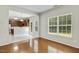Light-filled dining area with hardwood floors next to kitchen with wood cabinets at 160 Chandler Springs Dr, Holly Springs, NC 27540