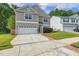 Charming two-story home showcasing neutral siding, a two-car garage, and well-manicured lawn at 160 Chandler Springs Dr, Holly Springs, NC 27540